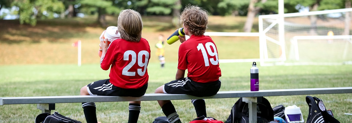 Phoenixville 9-26-15-78-X3 Two soccer players sitting on a bench, watching a game