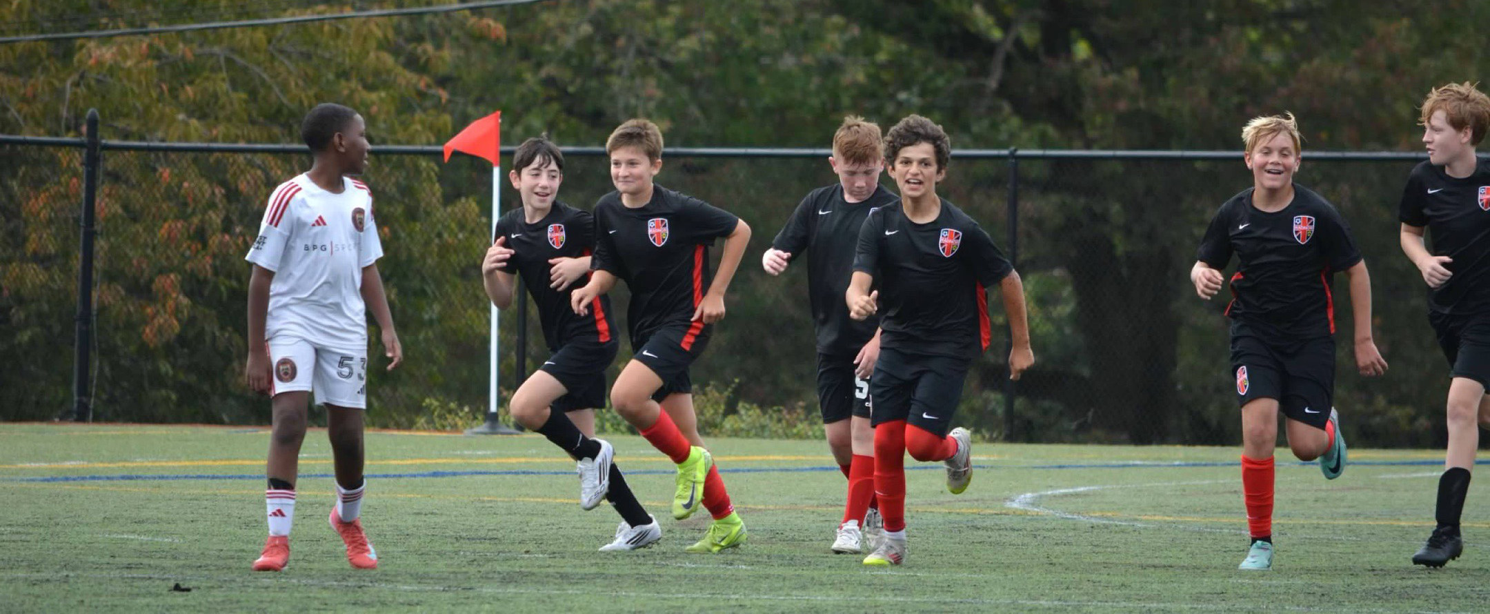 Kids on a soccer team running together.